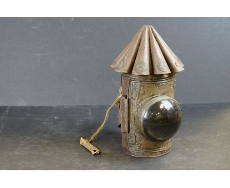 A vintage lantern with domed magnified lens and ornate decoration together with a barge ware storm lantern. 