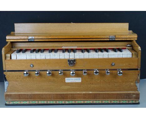 An Indian portable folding harmonium with carry bag. 