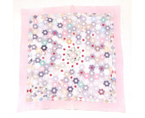 Late 19th Century Country Patchwork Quilt, with hexagonal coloured cotton flower head patches to the front, within a border o