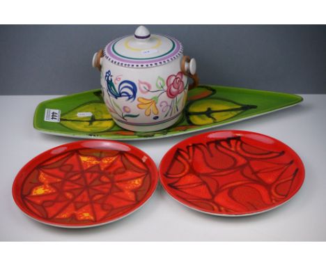 A small collection of Poole pottery to include Delphis pattern plates and a floral pattern biscuit barrel. 