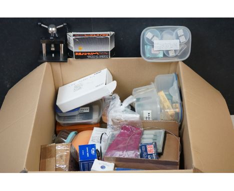 A collection of watch and clock repair tools and parts to include an ultrasonic cleaner, glass kit and mini press. 