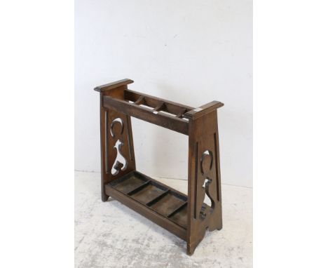 In the manner of Liberty's, Art Nouveau Oak Four Section Stick Stand with metal drip tray, 67cms long x 74cms high 