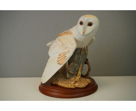 A Franklin Mint porcelain hand painted Barn Owl on wooden plinth. 