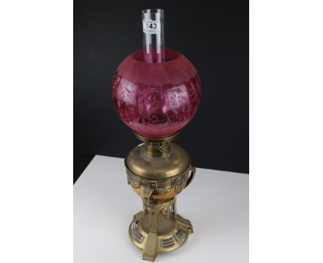 Victorian Aesthetic Movement Brass Oil Lamp with Cranberry Globular Glass Shade, 59cms high 