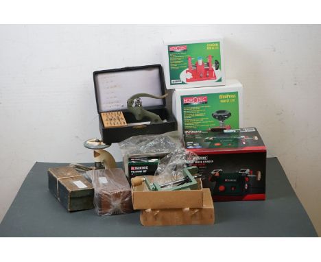 A collection of watch and clock repair tools to include a mini press, a bench grinder and a case crab. 
