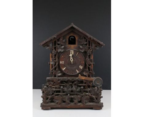 Late 19th / Early 20th century Black Forest carved Oak Cased Cuckoo Clock, with paper label to verso for the retailer Tritsch