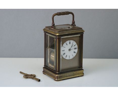 An antique brass cased carriage clock with repeater, complete with case and key. 