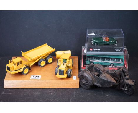 A German Conrad die cast D400 Caterpillar dump truck and NZG Caterpillar 966E wheel loader, both 1/50 scale and mounted on a 