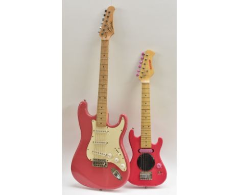 A Gould Stratocaster type electric guitar, gloss pink finish with white pickguard, maple neck; and a mini electric speaker gu