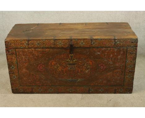 A 19th century, possibly Tibetan, polychrome hardwood twin handled carrying trunk, with applied floral decoration. H.59 W.120