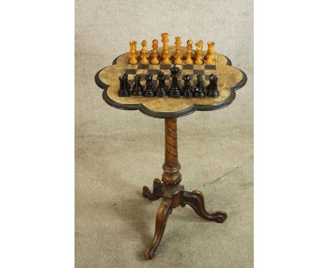 A late 19th century walnut games table with chessboard design with central twisted column raised on three splayed supports te