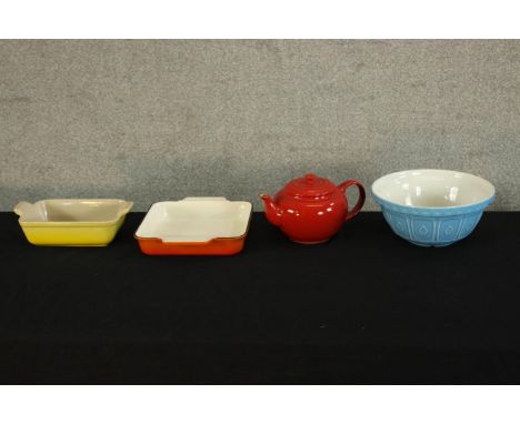 A yellow ceramic Le Creuset oven dish together with a ceramic bowl, over dish and red ceramic Le Creuset teapot. Stamped to b