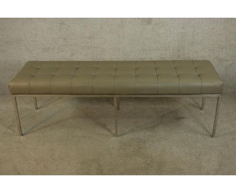 A contemporary Knoll style button grey leather seated bench raised on chome plated square supports. H.48 W.157cm. 