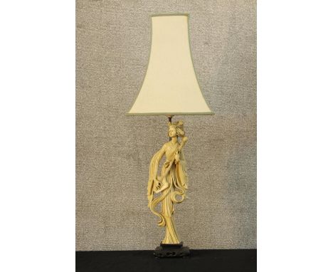 A 20th century composite figural table lamp moulded in the form of a Chinese lady raised on pierced hardwood stand. H.80cm. 