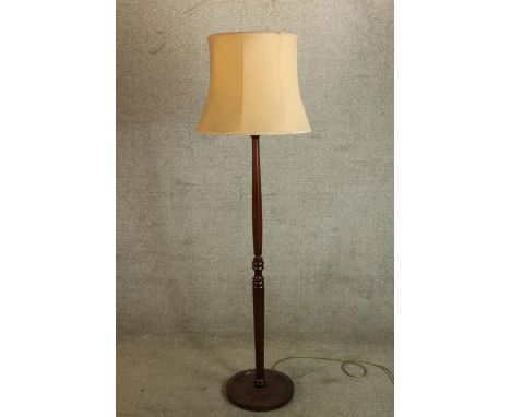 A 20th century mahogany standard lamp raised on circular feet. H.170cm. 