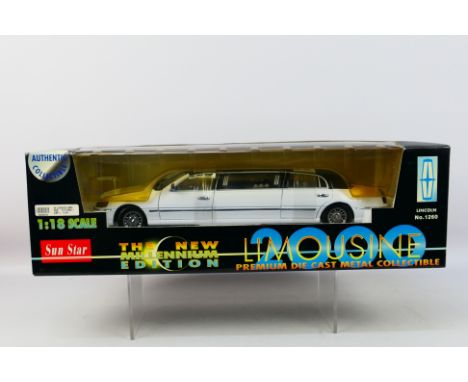 Sun Star - A boxed 1:18 scale Sun Star Millenium Edition Limousine. The model in white with black roof appears Mint, housed w