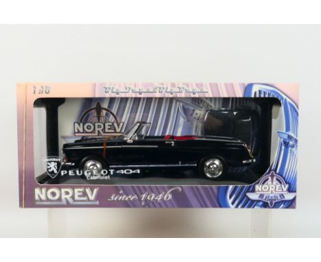 Norev - A boxed Norev #184763 1:18 scale 1965 Peugeot 404 Cabriolet. The model in black appears to be in Mint condition, hous