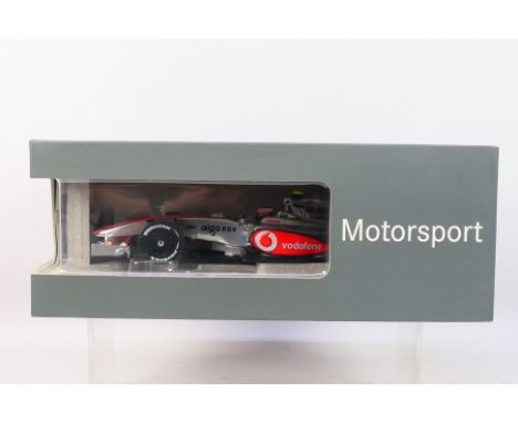 Minichamps - A boxed 1:18 scale Mercedes dealer edition Vodafone McLaren Mercedes MP4-24 Heikki Kovalainen 2009 car # B669600