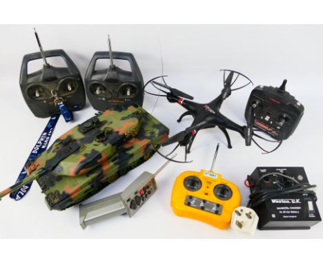 A group of radio controlled vehicles, a Hen Long 1:24 scale Battle Tank with controller; X ptrone drone with controller; plus