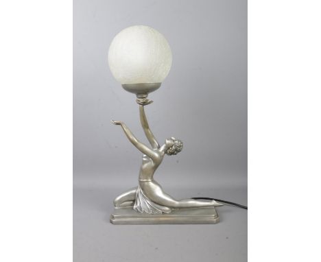 An Art Deco style table lamp formed as a woman with outstretched hands supporting a spherical crackle ball shade. Produced by