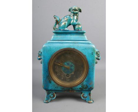 A ceramic mantle clock in the Chinese style possibly by Minton, in a turquoise glaze and with Foo Dog finial and masks.  Some