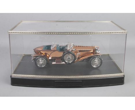 A Franklin Mint 1:24 scale 1921 Rolls Royce Silver Ghost diecast model with specially fitted copper colour body. Housed in di