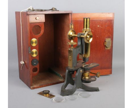 A mahogany cased Negretti &amp; Zambra brass bodied microscope, with adjustable column, lenses and slides. Height of case: 30