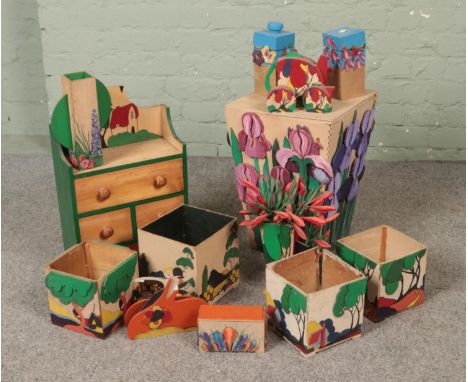 A collection of decorative wooden boxes/displays, mostly in the style of Clarice Cliff.  