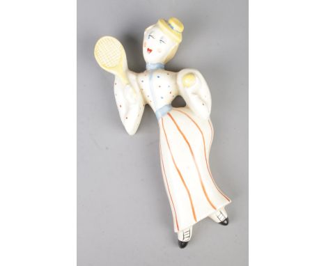 A Crown Devon pottery wall plaque formed as a female tennis player from the Countries of the World collection designed by Kat