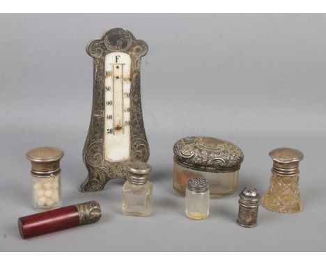 A collection of silver mounted and silver topped items, to include scent bottle, hair tidy, pepperettes and thermometer for r
