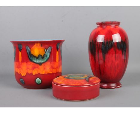 Three pieces of Poole pottery, to include Volcano planter, Peacock lidded trinket dish and Exodus vase. Height of tallest vas