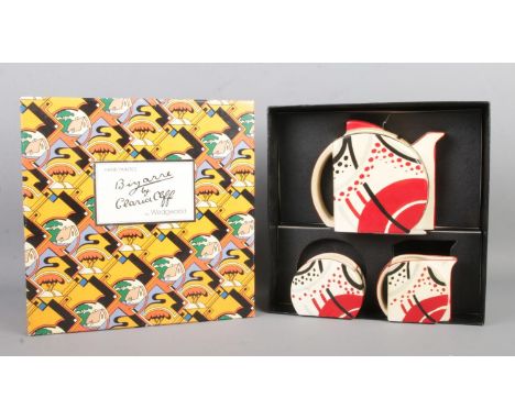 A boxed Wedgwood Clarice Cliff Bizarre three piece tea service, containing teapot, sugar bowl and milk jug.  Some paint peeli