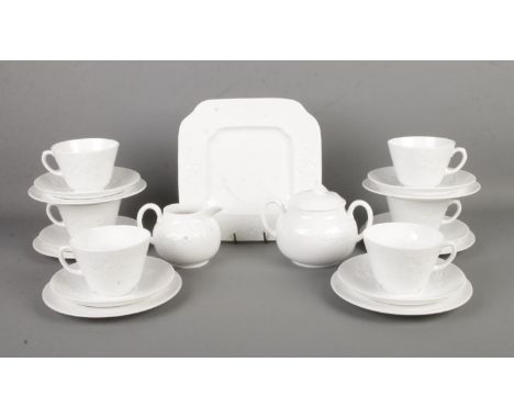 A Spode part tea service in the 'Blanche De Chine' design, featuring delicate floral design. Contains cups, saucers, milk jug