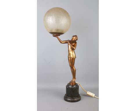 An Art Deco style table lamp, formed as a gilt maiden with outstretched arm, holding up a crackle shade. Height: 61cm.  Worki