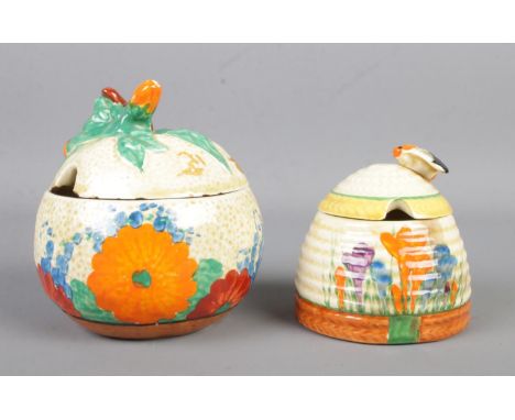 Two Clarice Cliff preserve pots, in the Crocus and Gayday patterns.  Hairline crack to the crocus example, chips to the rim a