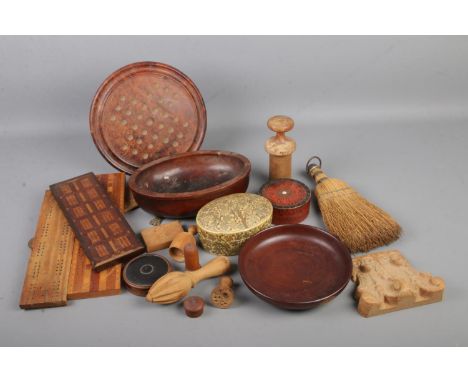 A collection of treen and wooden items including butter stamps, bowls, papier-mâché trinket boxes, bagatelle boards including