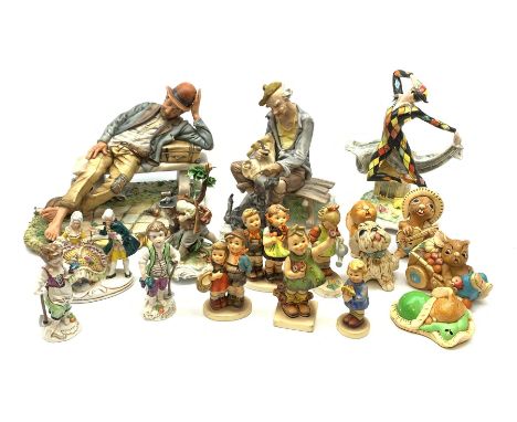 A collection of various figurines, comprising two Capodimonte figures modelled as tramps seated upon benches, together with a
