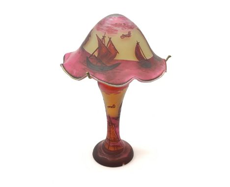 An Art Nouveau style glass table lamp, in the style of Galle, the waisted stem supporting a frilled mushroom shade, decorated