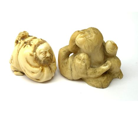 An early 20th century Japanese netsuke, modelled as a crouching figure with toad upon back, H3cm, together with a small early