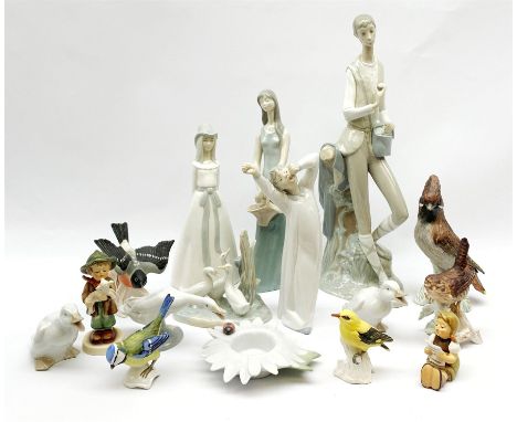 A group of figures, to include three Lladro examples, three Nao and a Nao model of a flower, five Goebel birds, two Goebel fi