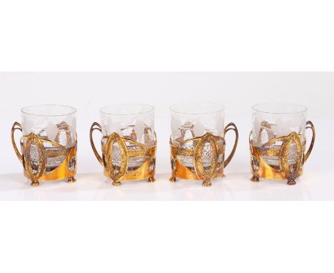 Set of four Sterling Silver gilt and etched glass cups, the glasses with a grape and swirl design held by a silver gilt cup f