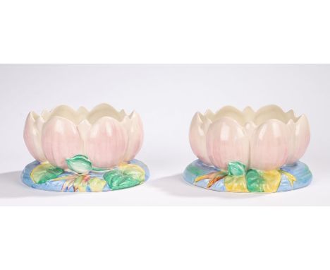 Pair of Clarice Cliff planters, modelled in the form of flower heads, 11.5cm highOne of the planters has had a drawing pin le