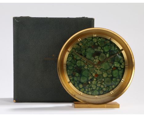 Jaeger le Coultre polished brass mantel clock, the marble effect dial with baton markers, on a reeded plinth base, 20cm diame