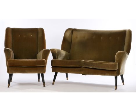 Green velvet upholstered two seat settee and armchair, with button backs, raised on turned ebonised tapering legs with brass 