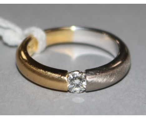 An 18ct two colour gold and solitaire diamond ring, size K.
