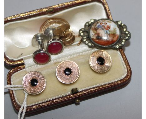 A cased set of three engine turned 9ct gold and black enamel dress studs and four other items.