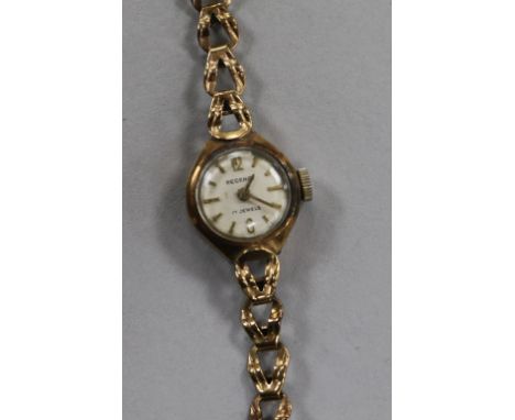 A lady's 9ct manual wind wrist watch on a 9ct gold bracelet.