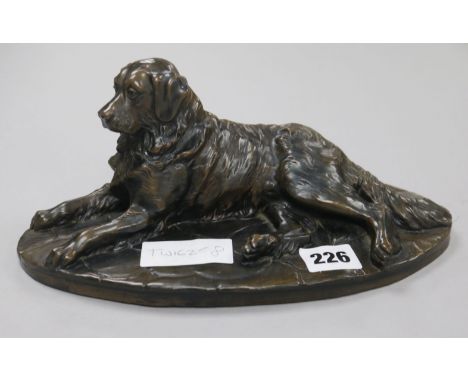 A Martin (20th century). A bronzed reclining model of a retriever