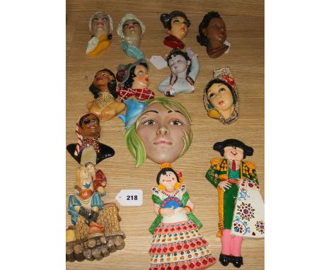 Ten Art Deco style plaster wall masks, various, a pair of figural plaques of a Spanish couple in costume and a Naturecraft wa