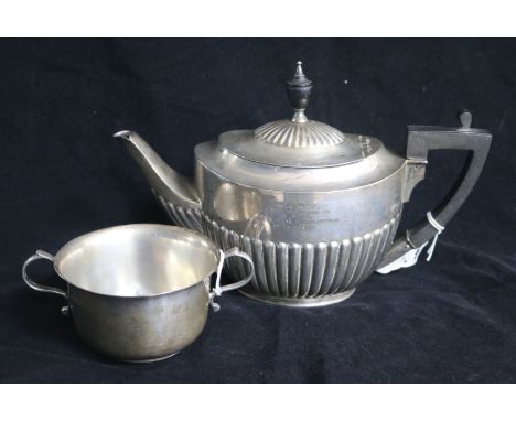 An Edwardian demi fluted silver oval teapot by William Hutton & Sons, London, 1907 and a silver porringer, gross 20.5 oz.